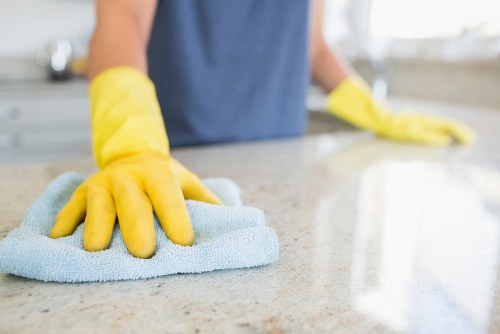 Local upholstery cleaner treating stains on a living room sofa